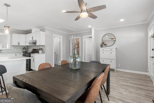 kitchen with white cabinetry, crown molding, stainless steel fridge with ice dispenser, kitchen peninsula, and pendant lighting