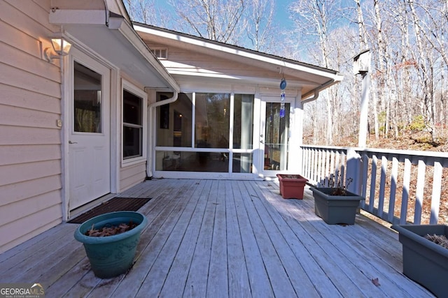 wooden terrace featuring a sunroom