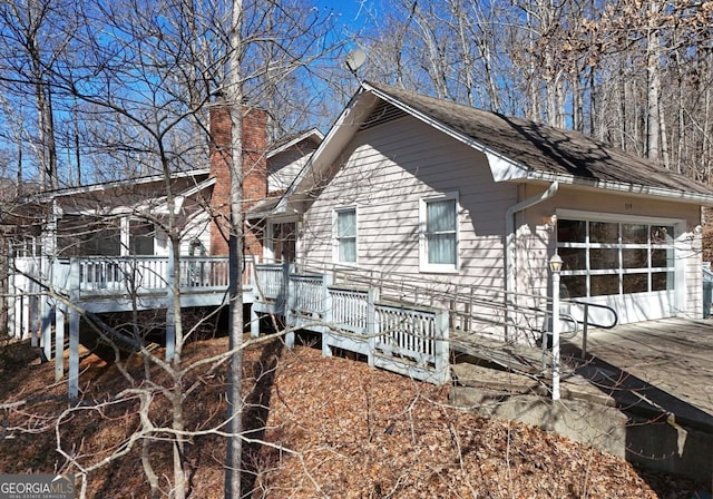 view of property exterior featuring a wooden deck