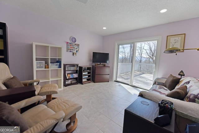 tiled living room featuring a textured ceiling