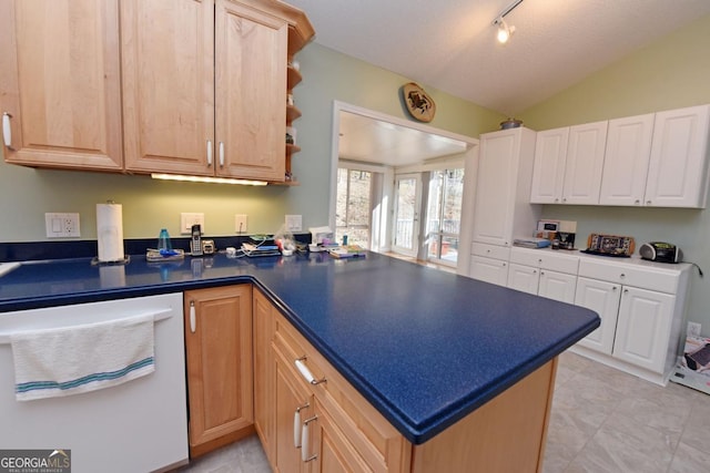 kitchen featuring lofted ceiling, white dishwasher, light brown cabinetry, and kitchen peninsula