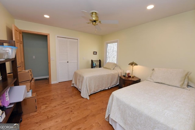 bedroom featuring a closet, ceiling fan, and light wood-type flooring