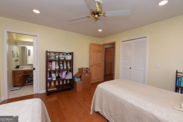 bedroom with hardwood / wood-style flooring, a closet, ceiling fan, and ensuite bathroom