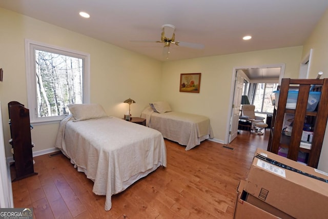 bedroom with hardwood / wood-style flooring and ceiling fan