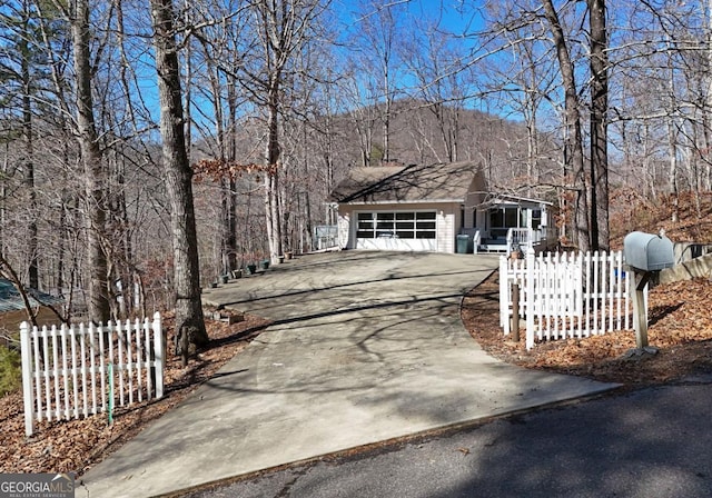 view of front of home with a garage and a mountain view