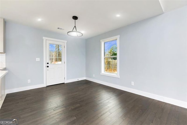 unfurnished dining area featuring dark hardwood / wood-style floors