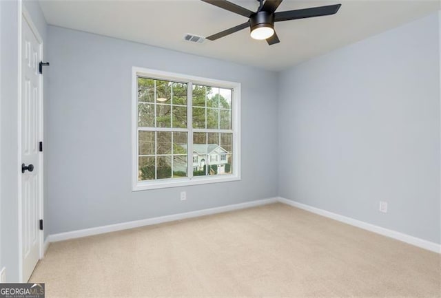 carpeted spare room with ceiling fan