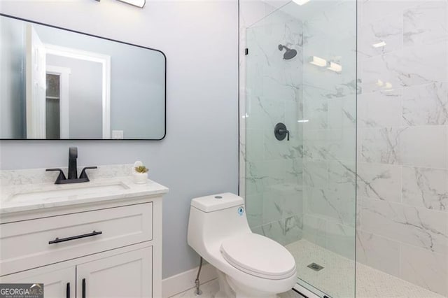 bathroom with vanity, toilet, and a tile shower