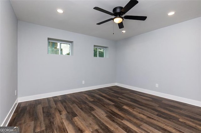 empty room with ceiling fan and dark hardwood / wood-style floors