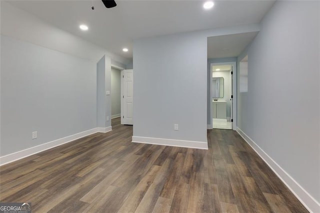 spare room featuring ceiling fan and dark hardwood / wood-style floors