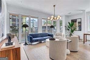 living room featuring a notable chandelier and light hardwood / wood-style floors