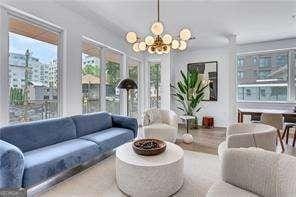 sunroom / solarium with an inviting chandelier