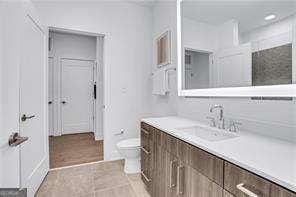 bathroom with vanity, tile patterned floors, and toilet