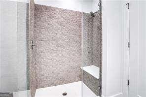 bathroom with tiled shower