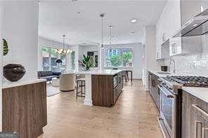 kitchen with pendant lighting, high end stainless steel range oven, a kitchen breakfast bar, dark brown cabinetry, and a kitchen island