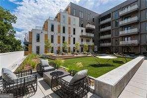 view of home's community with a patio and a fire pit