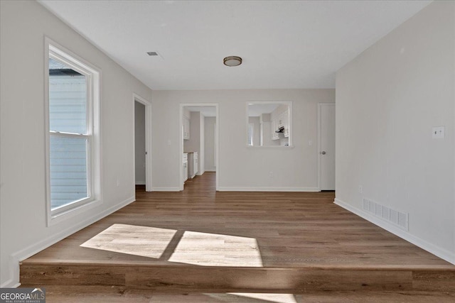 unfurnished room with hardwood / wood-style floors