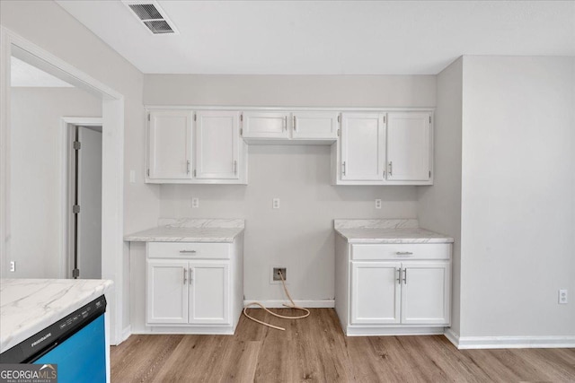 kitchen featuring white cabinetry, dishwasher, light stone counters, and light wood-type flooring