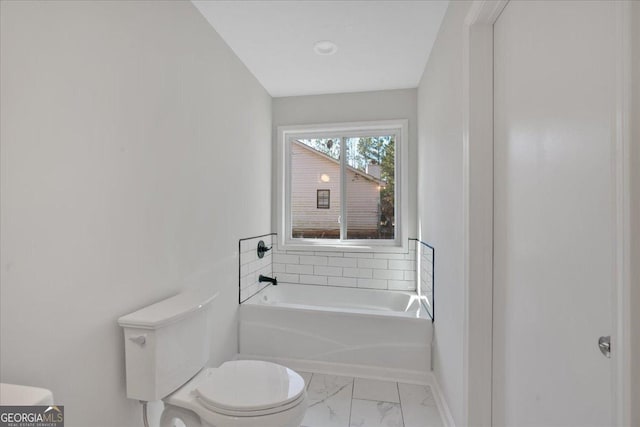 bathroom with a washtub and toilet