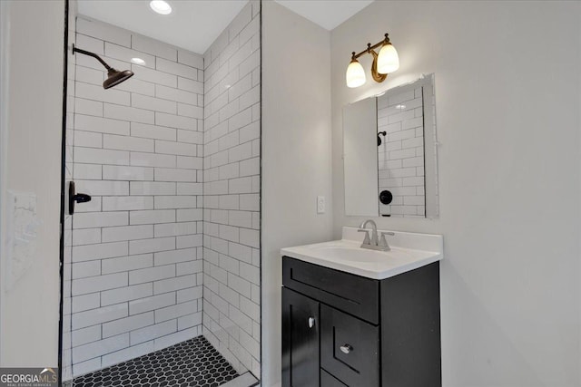 bathroom featuring vanity and tiled shower