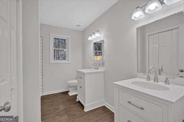 bathroom featuring hardwood / wood-style flooring, vanity, and toilet