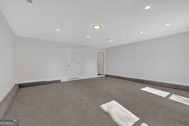 carpeted spare room with a textured ceiling