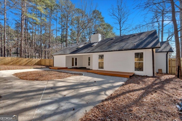 rear view of property with a patio and a wooden deck