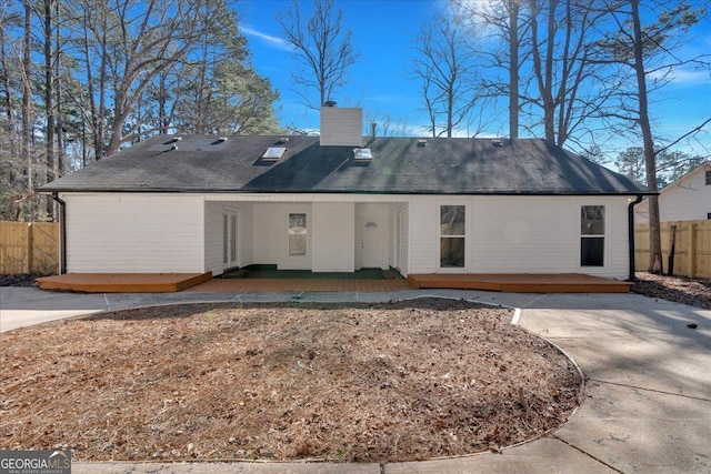 back of house featuring a deck