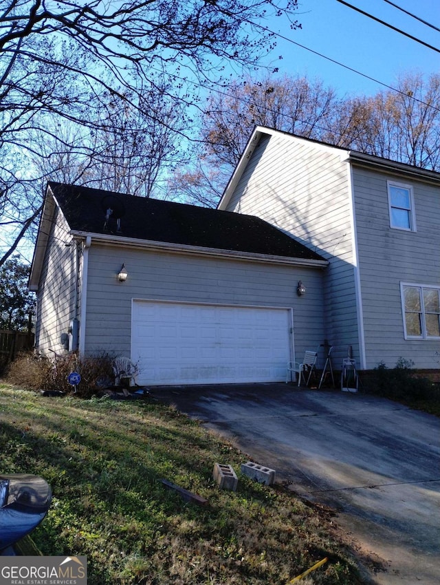 view of side of home featuring a garage