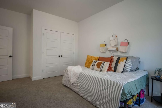 bedroom featuring light colored carpet and a closet