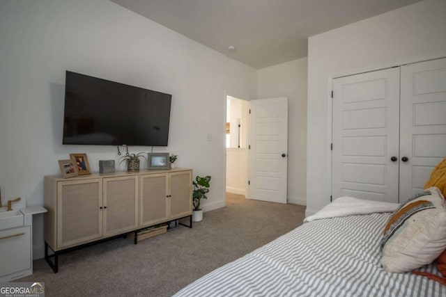 bedroom featuring a closet and dark colored carpet