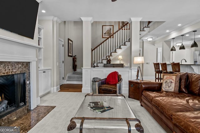 living room featuring a premium fireplace and ornamental molding