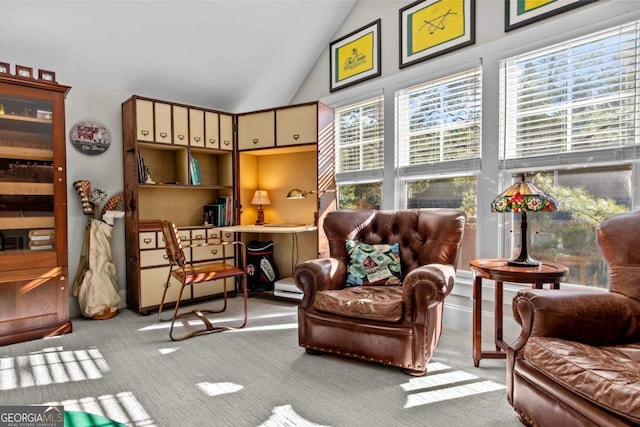 sitting room featuring light carpet, plenty of natural light, and vaulted ceiling