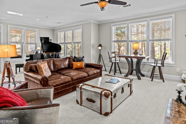 living room with ornamental molding, a healthy amount of sunlight, and ceiling fan