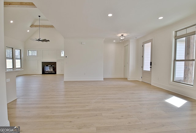 unfurnished living room featuring ceiling fan, plenty of natural light, and light hardwood / wood-style floors