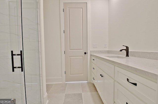 bathroom with vanity, a shower with door, and tile patterned floors