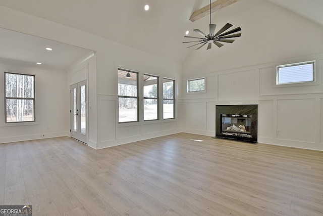 unfurnished living room featuring beamed ceiling, ceiling fan, high vaulted ceiling, and light hardwood / wood-style floors