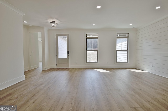 interior space featuring ornamental molding and light hardwood / wood-style flooring