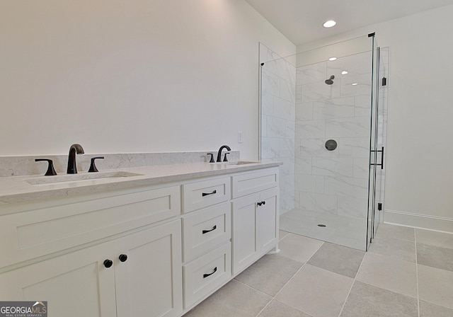 bathroom with tiled shower and vanity