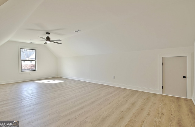 additional living space featuring ceiling fan, lofted ceiling, and light wood-type flooring