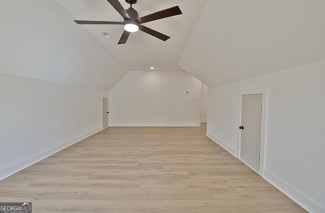 additional living space with ceiling fan, lofted ceiling, and light wood-type flooring