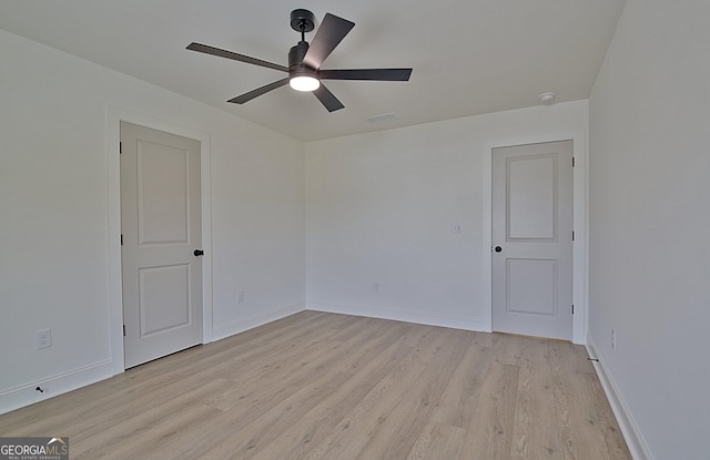 unfurnished room with ceiling fan and light wood-type flooring