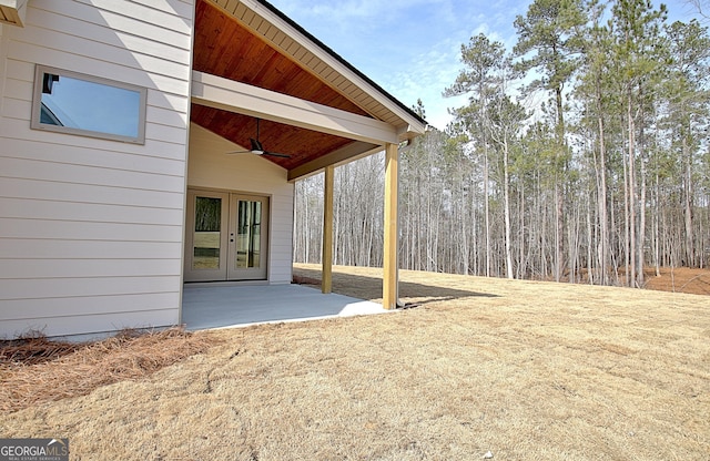 view of yard with a patio, ceiling fan, and french doors