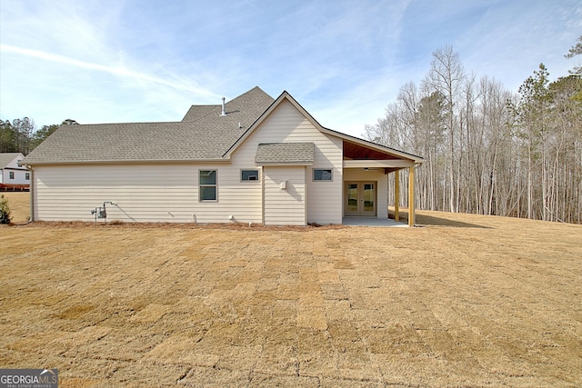 back of property featuring a patio, a lawn, and french doors