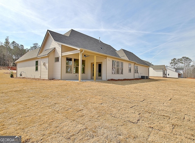 rear view of house featuring central AC, a patio area, and a lawn