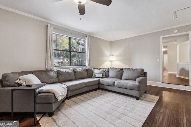 living room with hardwood / wood-style flooring, ceiling fan, and ornamental molding