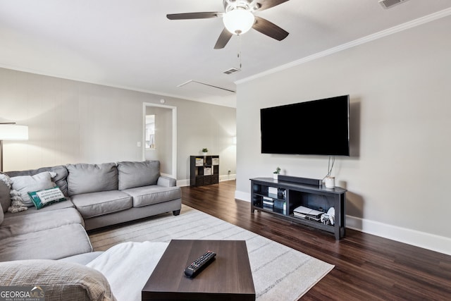 living room with crown molding, ceiling fan, and dark hardwood / wood-style flooring