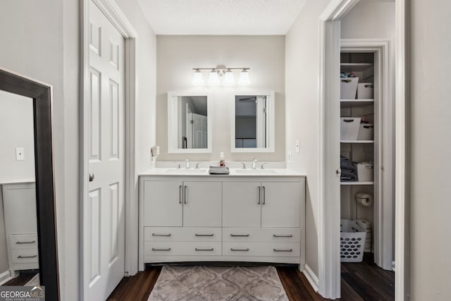 bathroom with vanity, hardwood / wood-style floors, and a textured ceiling