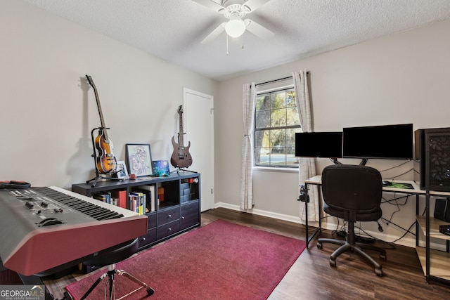 office space with ceiling fan, dark wood-type flooring, and a textured ceiling