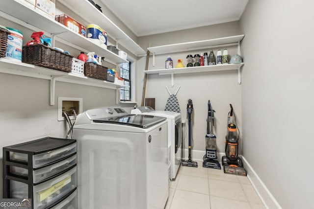 laundry area featuring light tile patterned flooring and washing machine and clothes dryer